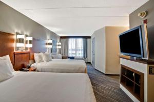 a hotel room with two beds and a flat screen tv at Hyatt Place Baltimore/BWI Airport in Linthicum Heights