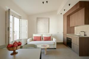 a living room with a couch and a table at U-Sense Granada Gran Vía in Granada