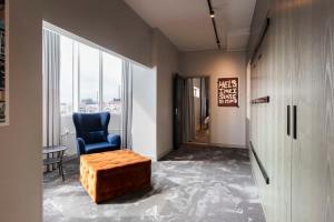 a hallway with a blue chair and a window at Radisson Blu Seaside Hotel, Helsinki in Helsinki +37 photos