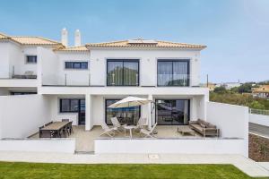 a villa with a view of the backyard at Almancil Elegant Villa With Pool by Homing in Almancil