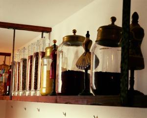 a shelf with two glass jars and a mirror at Villa Laetitia in Ponza