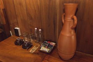 a vase sitting on top of a wooden table at Gahi Homestay in Hue