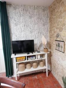 a television on a white shelf in a room at La Casa del Rio in Durtal +27 photos