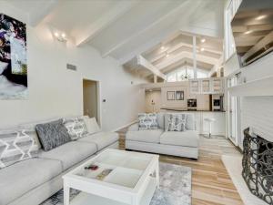 a living room with a couch and a fireplace at West Irving Palace Miami Style in Irving