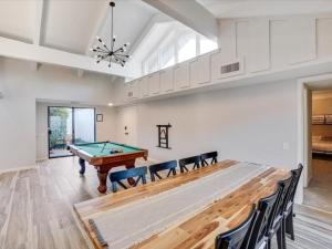 a living room with a pool table and chairs at West Irving Palace Miami Style in Irving