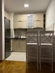 a kitchen with a counter and a chair in it at Apartment Shine in Konik