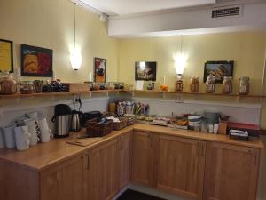 a kitchen with wooden cabinets and a counter top at Hotell Zlafen Bed & Breakfast in Karlskoga