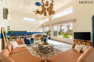 a living room with two couches and a tv at EKOSTAY Luxe - Hercules Villa in Igatpuri