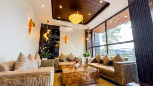 a living room with a couch and a table at Orbit Regency in Gangtok +13 photos