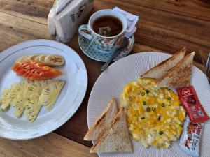 two plates of eggs and toast and a cup of coffee at MASYA Cottages in Gili Trawangan
