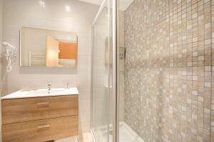 a bathroom with a sink and a shower at Andorra Family Snow Apartment - Happy Rentals in El Tarter
