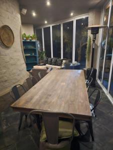 a wooden table and chairs in a living room at Castle Home in Centurion +132 photos
