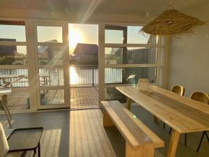 a room with a wooden table and chairs and a window at Spacious Waterfront Family Gem in Langelille