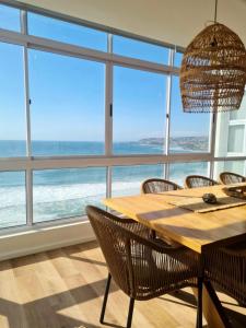 a dining room with a table and chairs and a large window at Point Village Accommodation - Ocean Two 43 in Mossel Bay