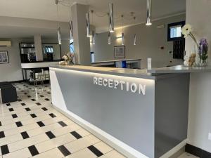 a reception desk in a room with a reception counter at Park Hotel Residence in Crema