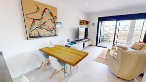 a living room with a table and a couch at Holidoo Travel "Casa Maru" in San Javier