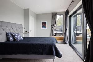 a bedroom with a bed and a large window at Exklusiv villa med pool & fri havsutsikt in Sommarbo +44 photos
