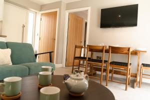 a living room with a couch and a table at Fieldside Cottage in Scarborough