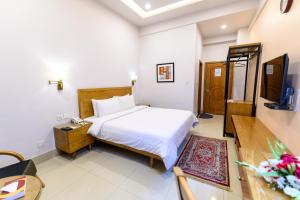 Postel nebo postele na pokoji v ubytování Hotel One Mansehra