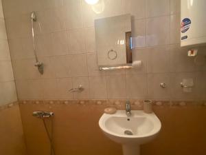 a bathroom with a sink and a mirror at Dvata Smurcha Central Apartments - Free Parking in Bansko +22 photos
