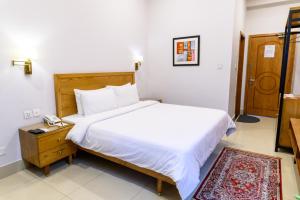 Postel nebo postele na pokoji v ubytování Hotel One Mansehra + 19 fotografií
