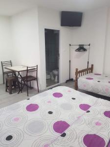 a bedroom with a bed and a table and a table and chairs at Garden House Apartments Struga in Struga