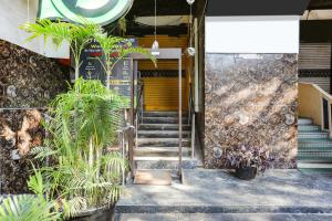 a stairway with a yellow door and some plants at Comfy Stay Hotels 2nd Floor in New Delhi