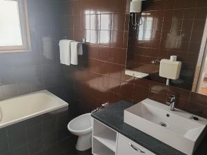 a bathroom with a sink and a toilet and a mirror at RIBARIĆ in Banjol +110 photos