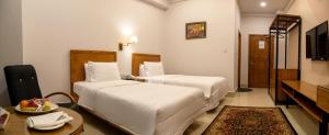 Postel nebo postele na pokoji v ubytování Hotel One Mansehra