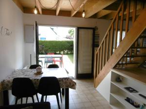 a dining room with a table and chairs and a staircase at Maison 4 pièces 5 personnes à 200 m de la plage - MAIANN in Sarzeau +13 photos