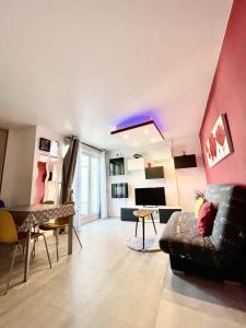 a living room with a couch and a table at 15 min walk to DisneylandParis, 5 min walk to Val d'Europe Mall and train RER A, Monyhome apartment for 4 persons in Chessy