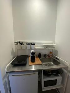 a small kitchen with a sink and a counter at Le Studio in Montauban +24 photos