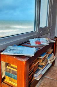 a table with books on it next to a window at Masia del Viento in Mar del Sur +67 photos