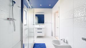 a white bathroom with a sink and a toilet at Dom Marcello with jacuzzi, Sun & Snow in Zastań +21 photos