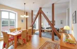 a dining room and living room with a table and chairs at Lovely Apartment In Krakow Am See in Krakow am See