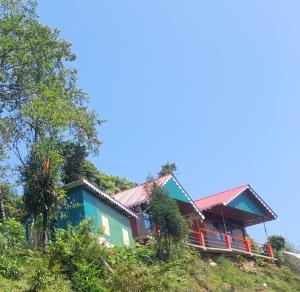 a house on the side of a hill at Adithyanaman Cottage Homestay in Darjeeling