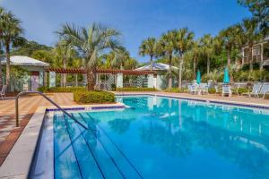 a swimming pool with blue water in a resort at Rockaway Beach in Santa Rosa Beach