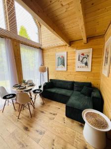 a living room with a green couch and a table at Domek Rykowisko Korbielów 1 in Korbielów