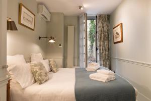a bedroom with a bed with towels on it at Pick A Flat's Apartments in Saint Germain - Paul-Louis Courier in Paris