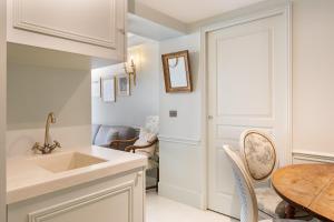 a kitchen with a sink and a table at Pick A Flat's Apartments in Saint Germain - Paul-Louis Courier in Paris +40 photos