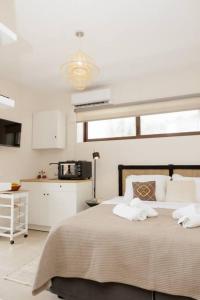a bedroom with a bed with two towels on it at Elaída - Studio,Θέα θάλασσα & βουνό,Μάνη in Skoutarion