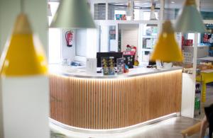 a counter in a store with yellow lights at Coral Compostela Beach Golf in Playa de las Americas