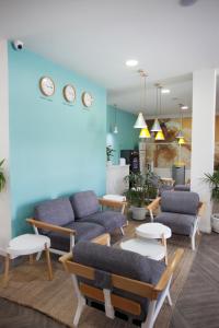 a living room with a couch and chairs and tables at Coral Compostela Beach Golf in Playa de las Americas
