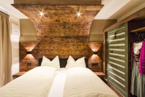 a bedroom with two beds and a brick wall at Chalet Da Mont in Selva di Val Gardena