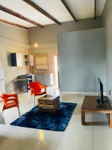 a living room with a couch and a table at Onothweni Lodge in Manguzi +27 photos