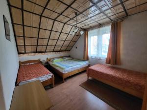 a room with two beds and a window at Erika Apartman in Balatonlelle