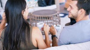 a man and a woman sitting at a table with cups at Coral Los Alisios in Los Cristianos