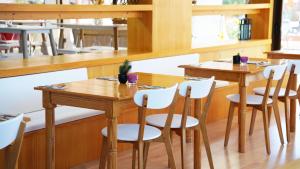 a dining room with wooden tables and white chairs at Coral Los Alisios in Los Cristianos +114 photos