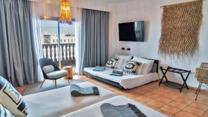 a living room with a couch and a chair at Coral Cotillo Beach in El Cotillo
