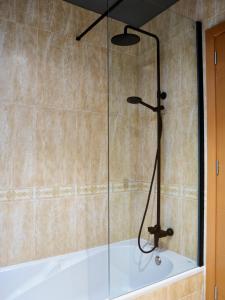 a shower with a glass door in a bathroom at Coral Cotillo Beach in El Cotillo